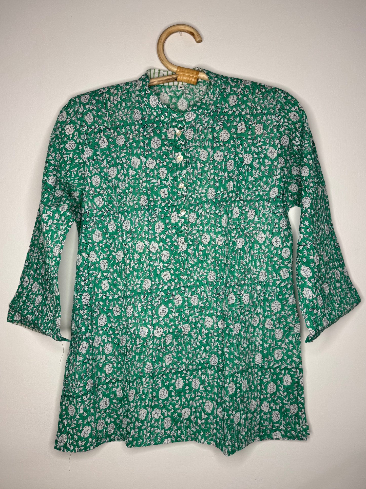 Green floral shirt on a white background