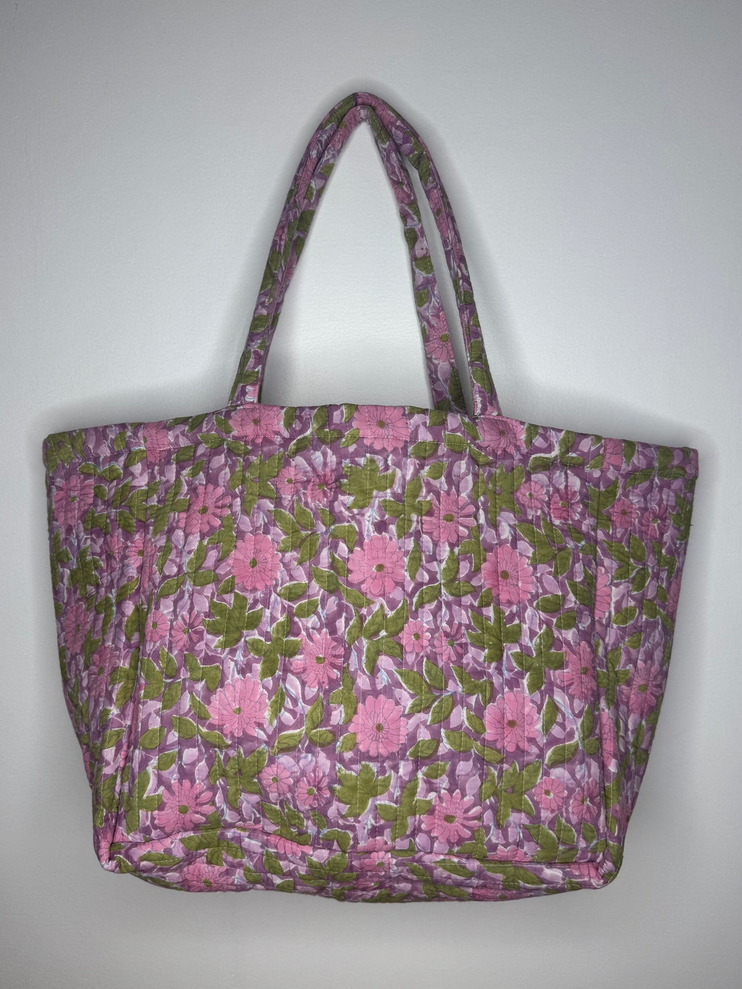 Floral-patterned tote bag on a plain background