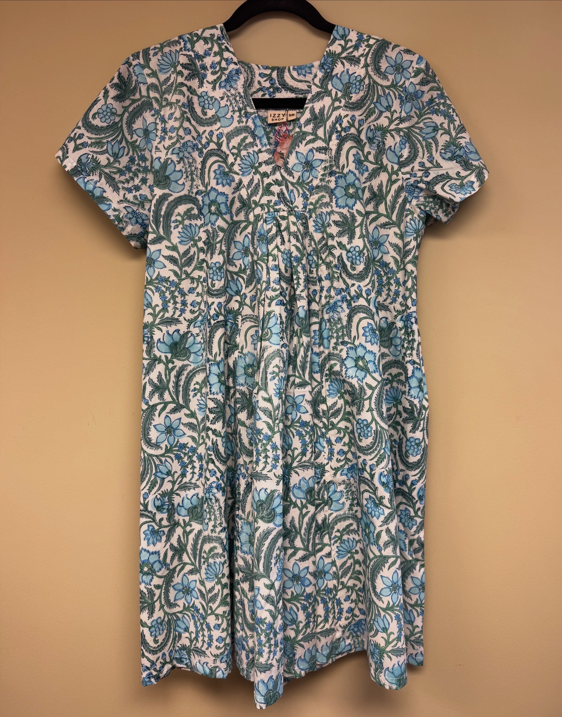 Floral patterned dress on a beige background