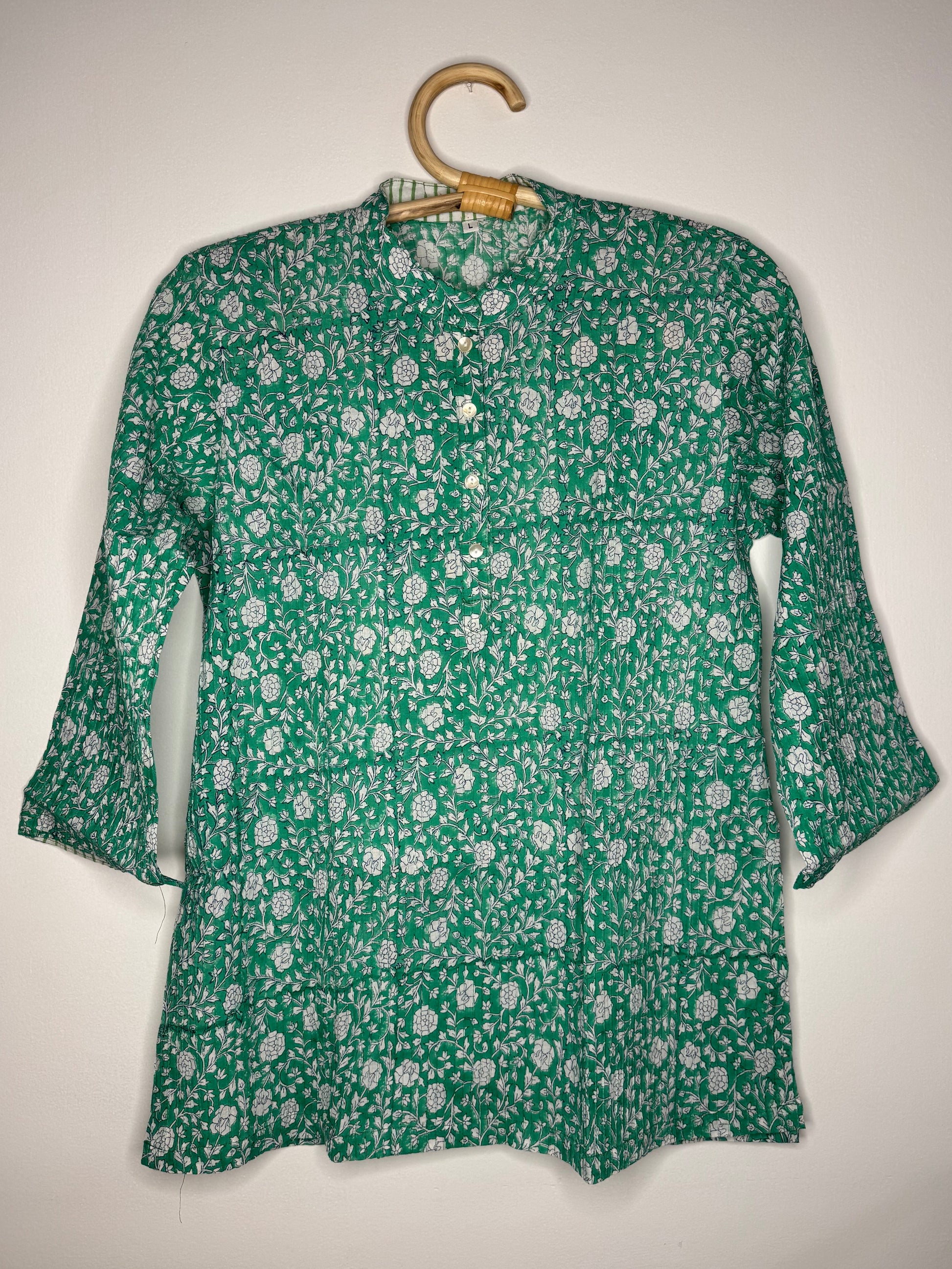 Green floral shirt on a white background