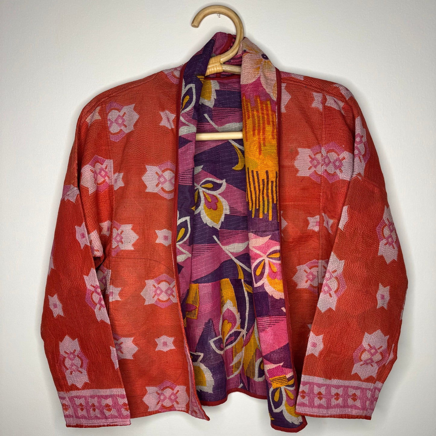 Kantha jacket against a white wall