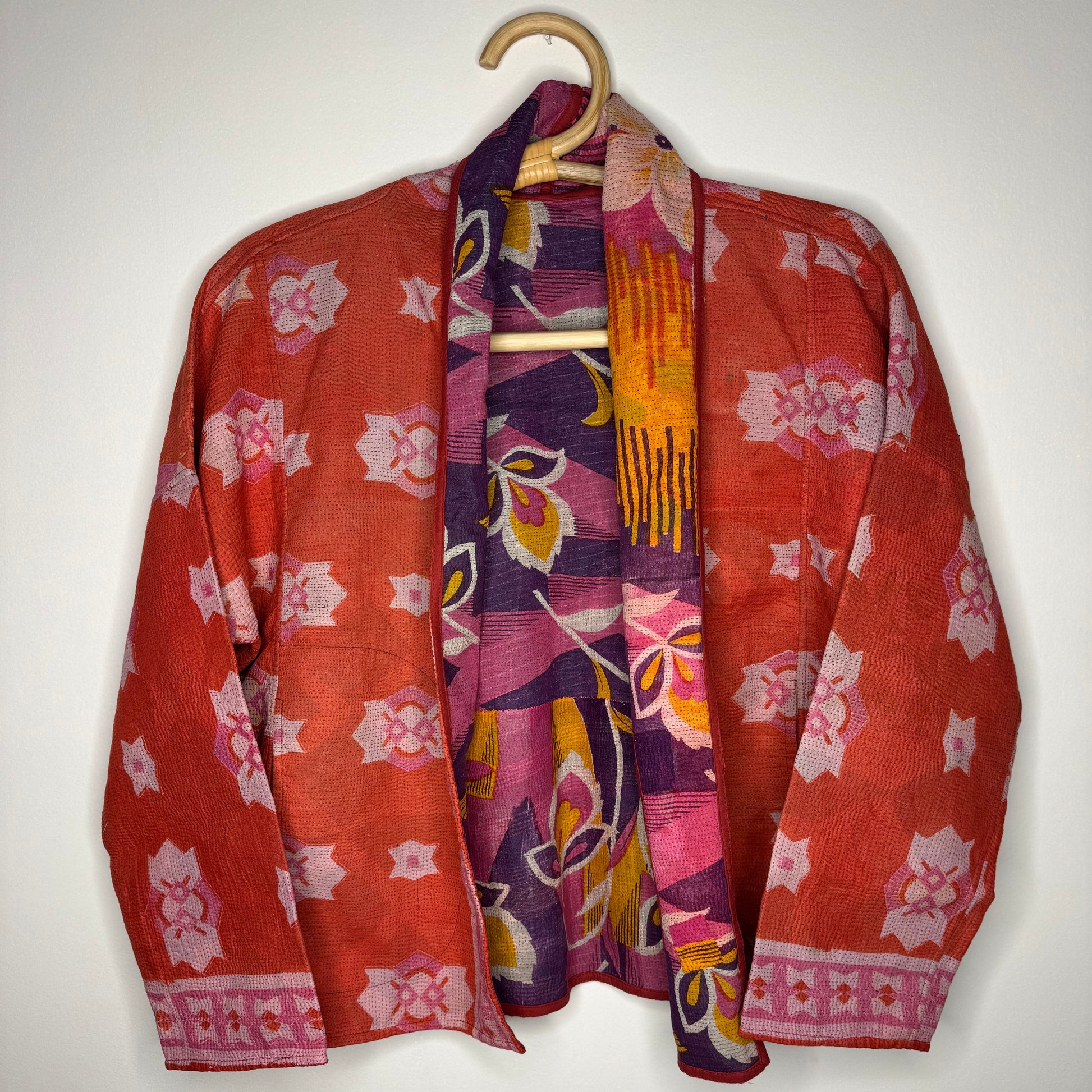 Kantha jacket against a white wall