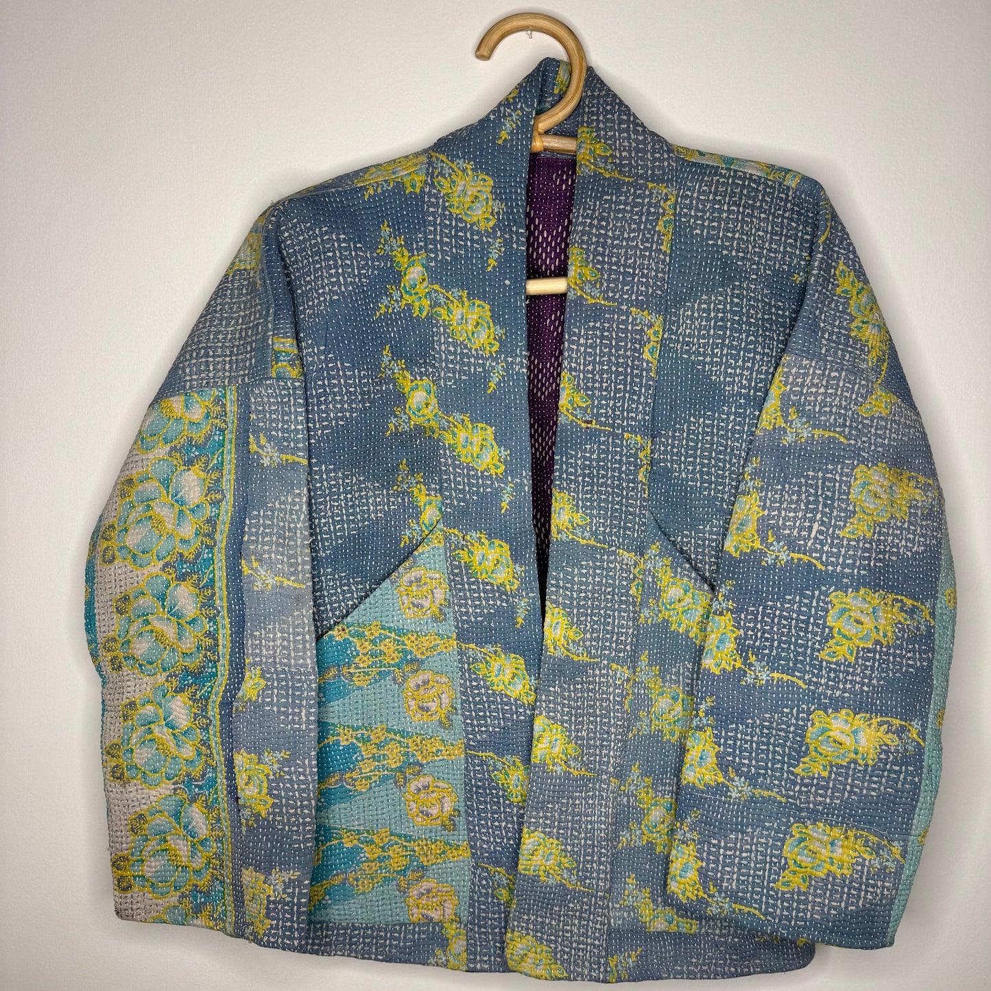 Kantha jacket against a white wall