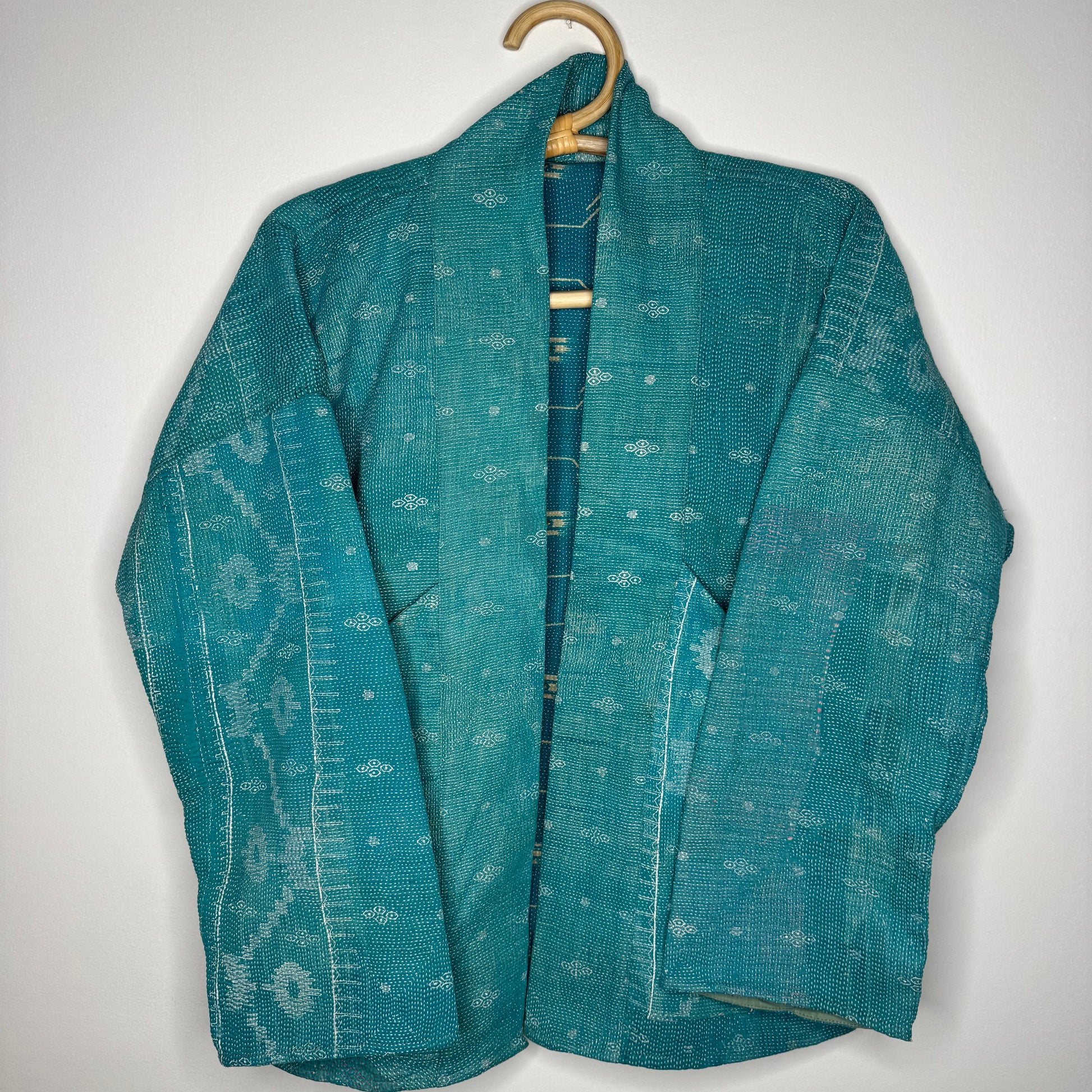 Kantha jacket against a white wall