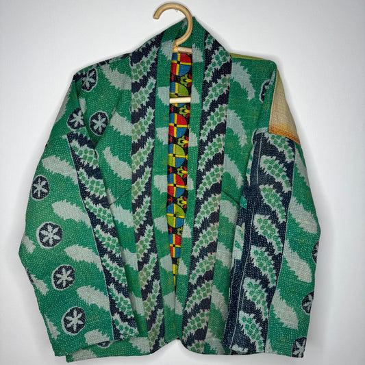 Kantha jacket against a white wall