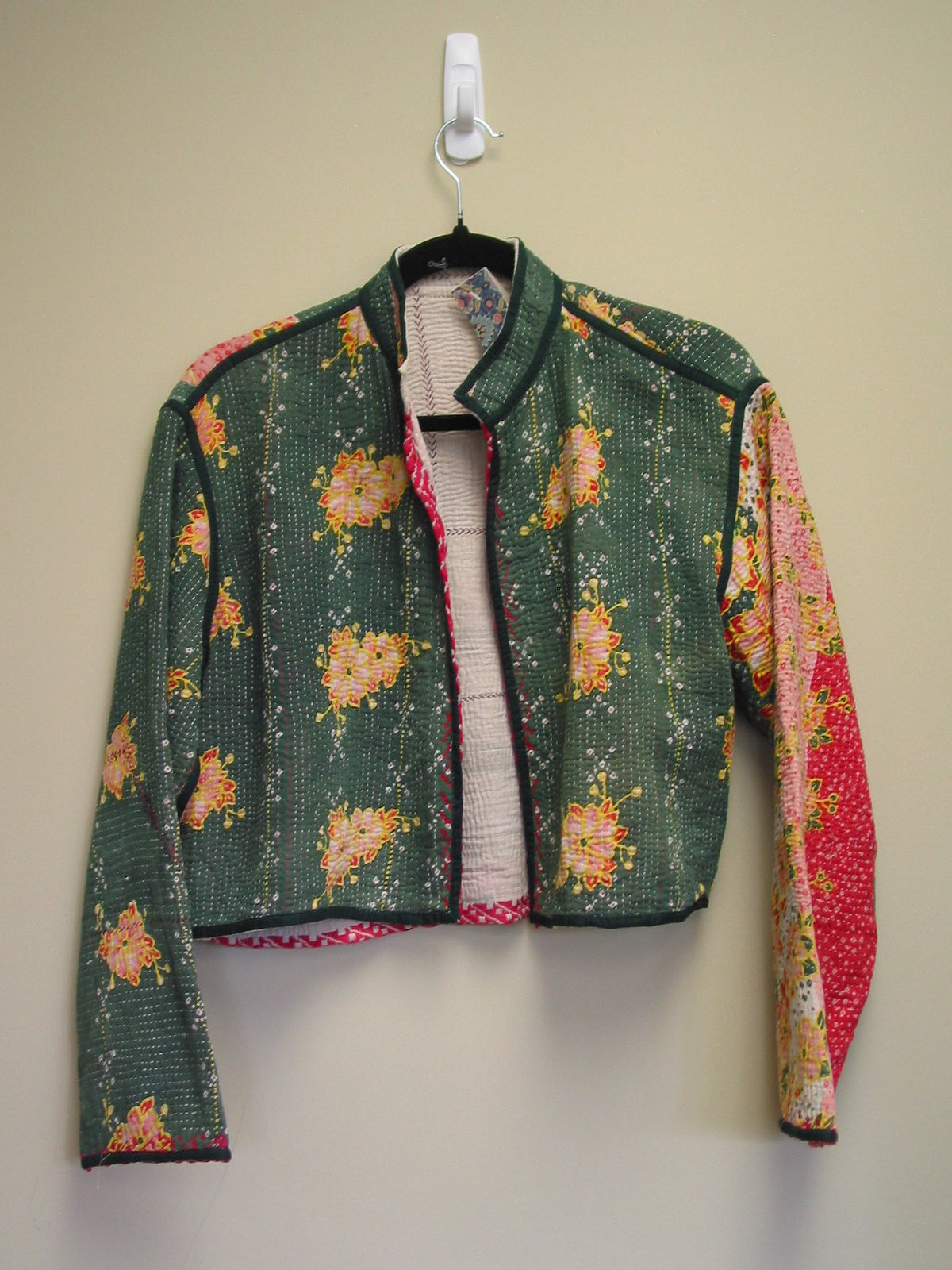 Kantha jacket with floral patterns on a beige background