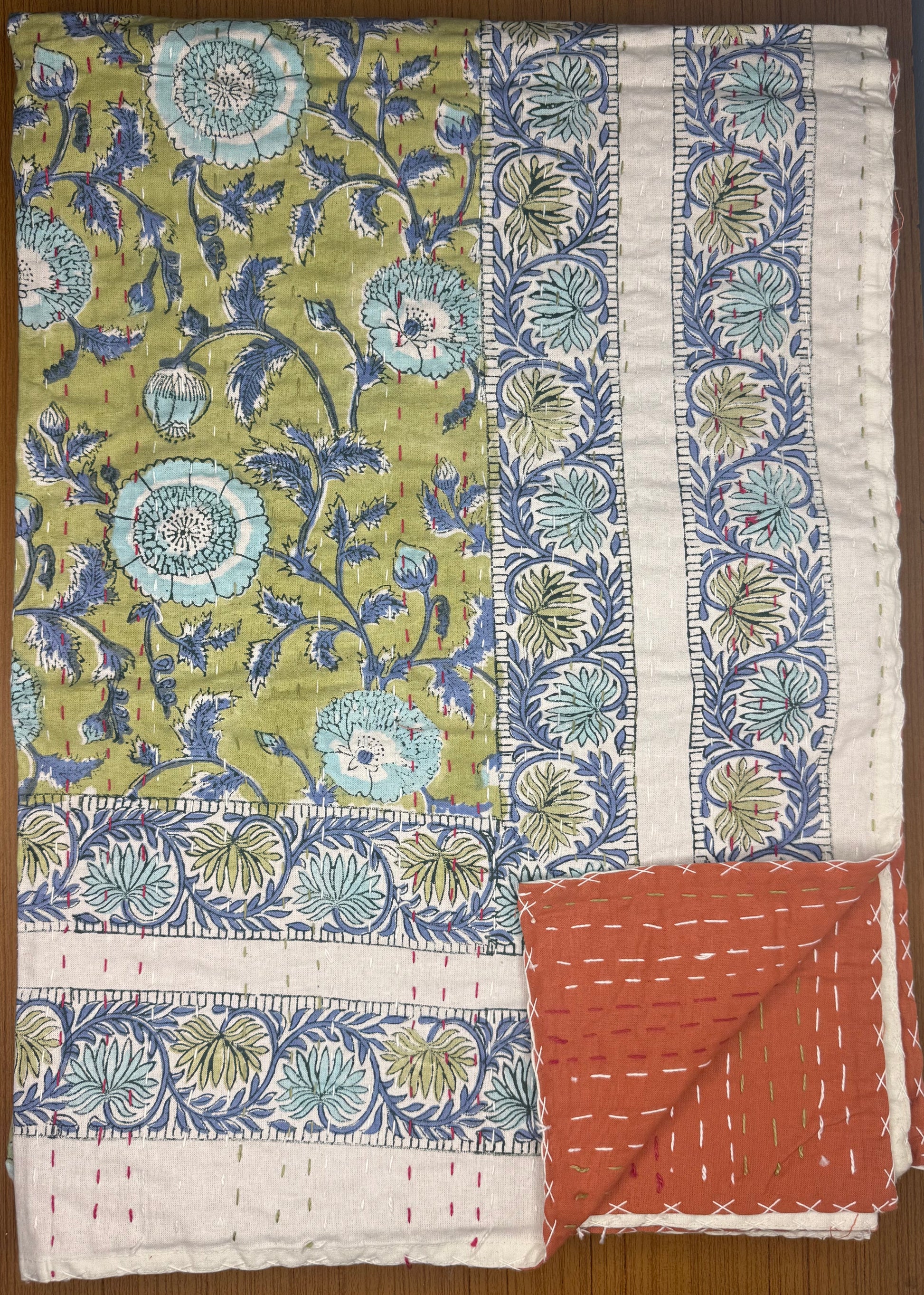 Floral-patterned fabrics on a wooden surface