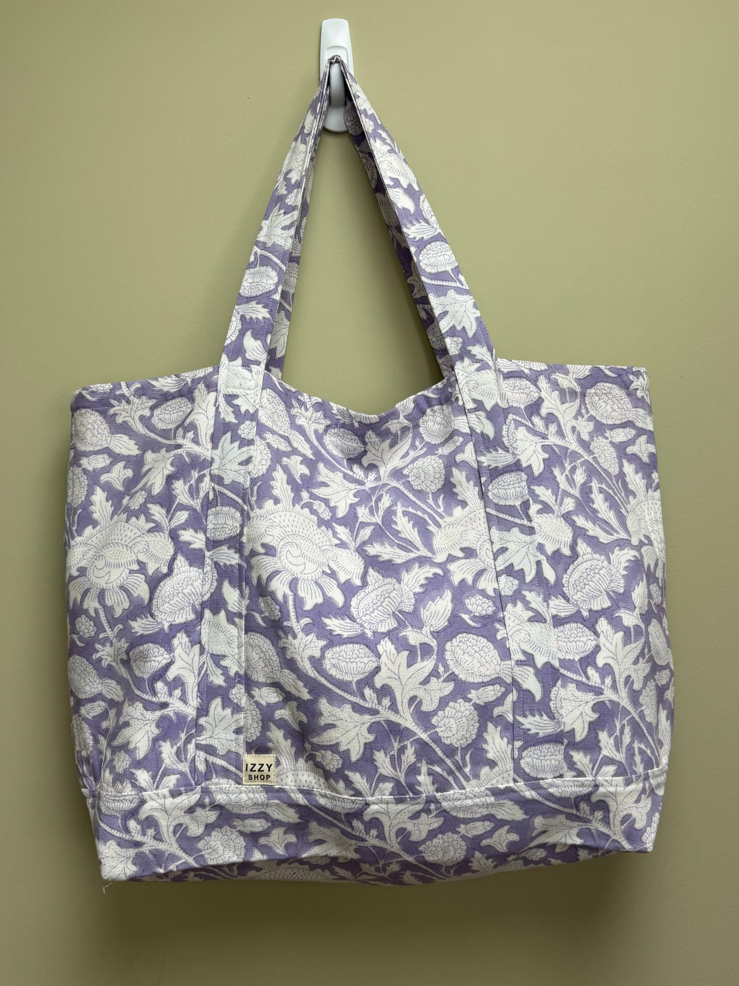 Floral-patterned tote bag on a beige background