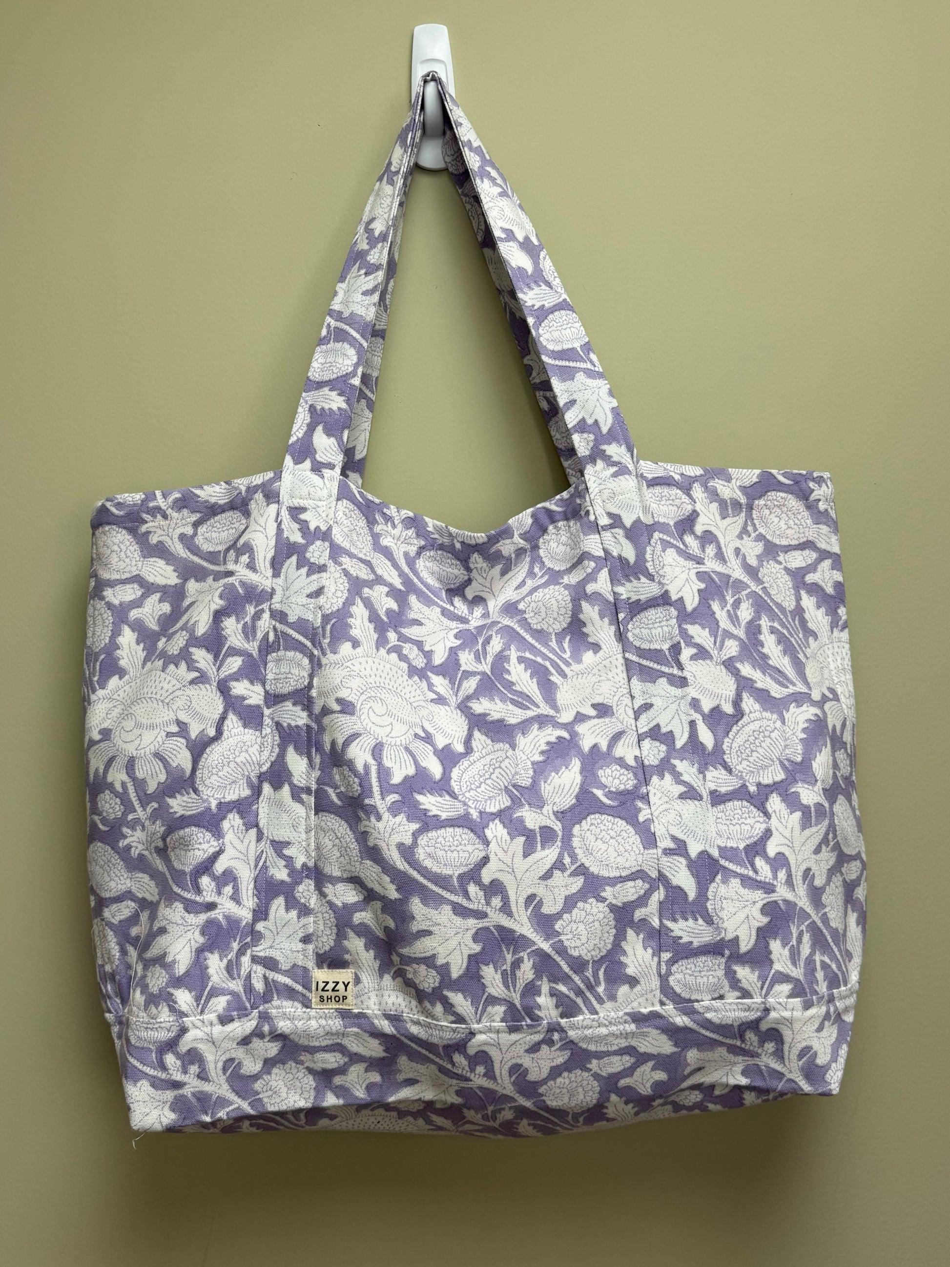 Floral-patterned tote bag on a beige background