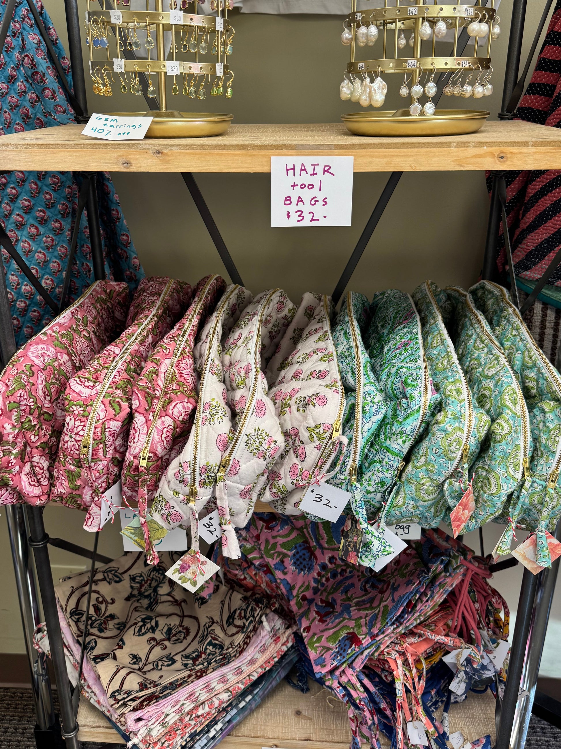 Pouches displayed on a rack with various patterns and colors.